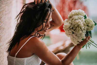 Midsection of woman holding flower bouquet