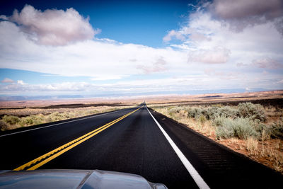 Road passing through landscape against sky