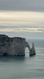 Scenic view of rock formation in sea against sky falaise aiguille littoral  manche 