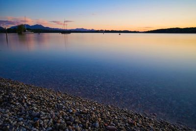 Scenic view of lake against sky during sunset