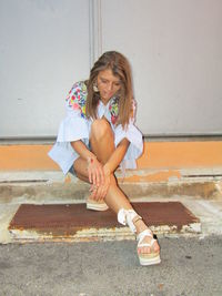 High angle view of girl sitting on staircase