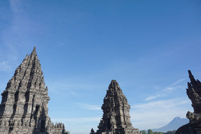 Low angle view of temple building against blue sky