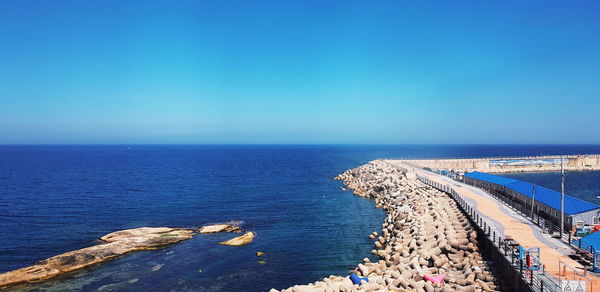 High angle view of sea against clear blue sky