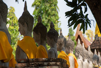 Statues in temple against building