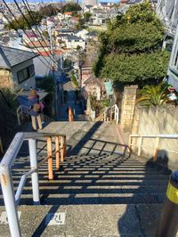 High angle view of people walking on steps in city