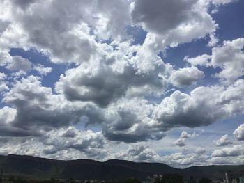 Low angle view of clouds over mountain