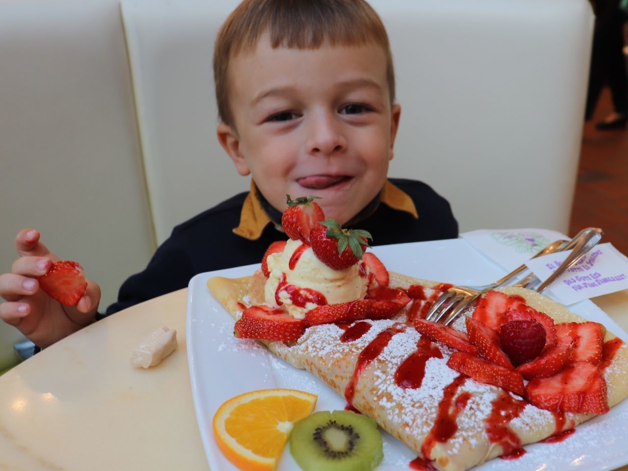 child, childhood, food and drink, food, portrait, indoors, headshot, one person, indulgence, front view, dessert, males, lifestyles, men, boys, real people, sweet food, cake, sweet, temptation, innocence