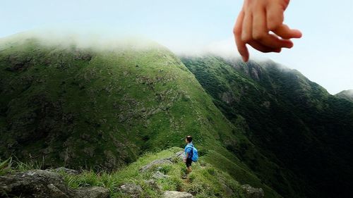 Two men on landscape against sky