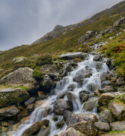 Scenic view of waterfall against sky