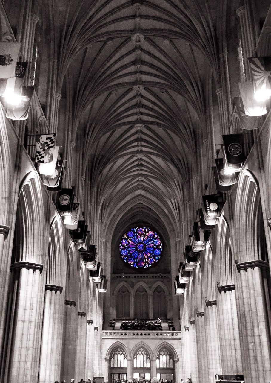 indoors, ceiling, arch, architecture, place of worship, religion, church, built structure, illuminated, interior, spirituality, low angle view, chandelier, lighting equipment, pew, ornate, hanging, cathedral