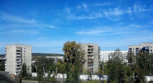 Buildings against cloudy sky