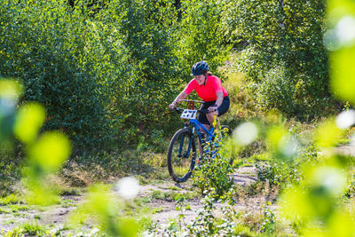 Woman cycling in forest