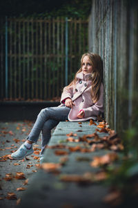 Portrait of young woman sitting on table