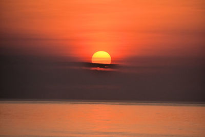 Scenic view of sea against romantic sky at sunset