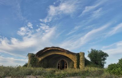 Old building on field against sky