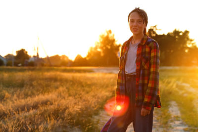 Teenage girl enjoying nature on summer sunny field. portrait of adorable smiling girl on field