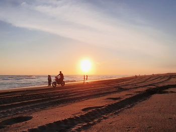 Scenic view of beach against sky during sunset