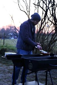 Man standing outdoors by the grill 