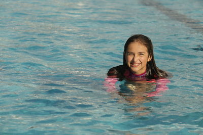 Portrait of young woman in swimming pool