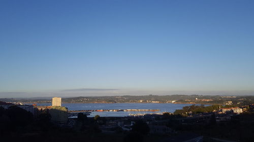 High angle view of cityscape against blue sky