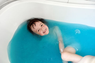 Portrait of smiling boy in swimming pool