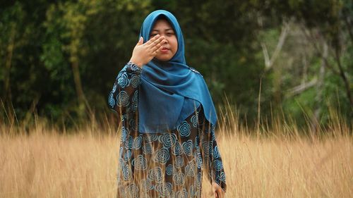 Woman wearing hijab on grassy field