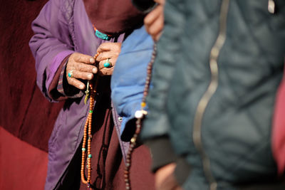 Close-up of hands with prayer beads
