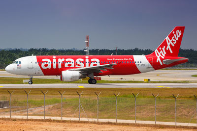 Airplane on airport runway against clear sky