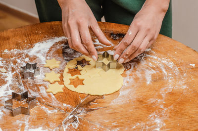 The cook kneads the cookie dough with his hands