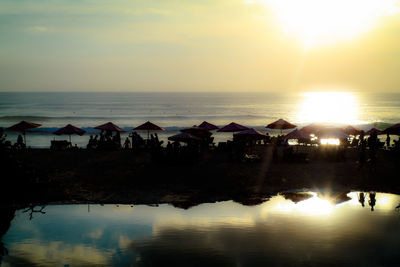 Scenic view of beach against sky during sunset