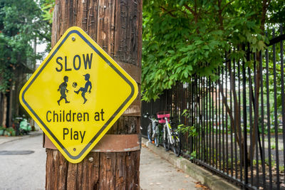 Close-up of warning sign on tree