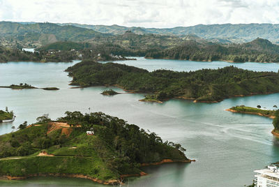 High angle view of sea and landscape against sky