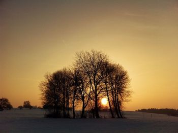 Snow covered landscape at sunset