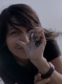 Portrait of woman holding seashells