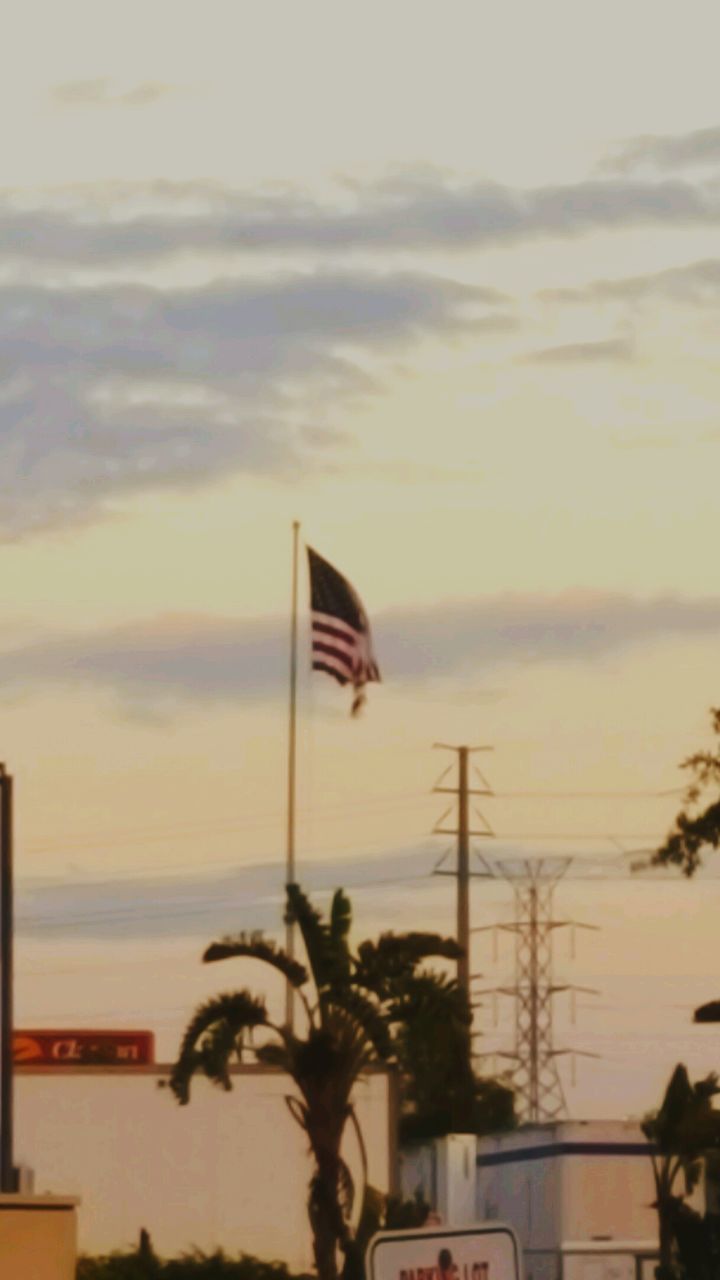 LOW ANGLE VIEW OF FLAGS FLYING AGAINST SKY