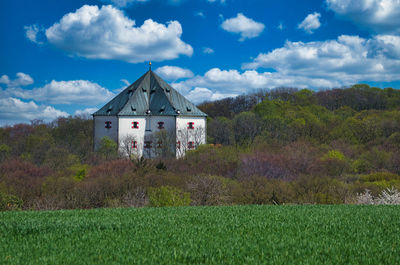 Built structure on field against sky