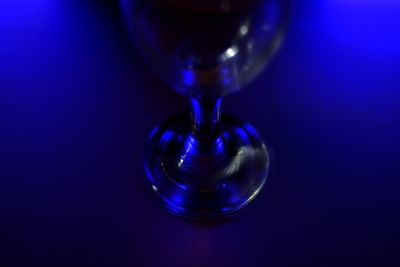 Close-up of bubbles in glass against blue background