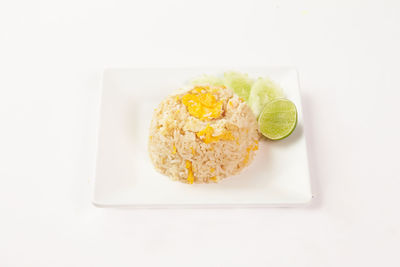 High angle view of food in plate against white background