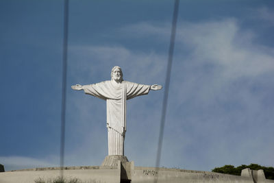 Low angle view of statue against blue sky