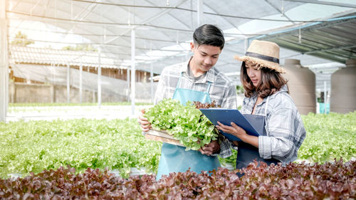 Young man working in greenhouse