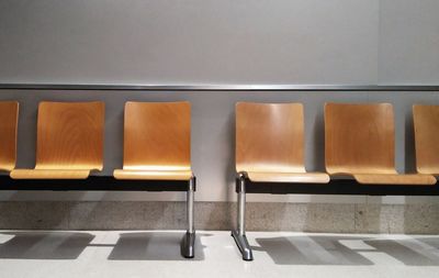 Empty chairs against wall