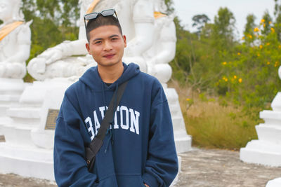 Portrait of a handsome young man standing outdoors