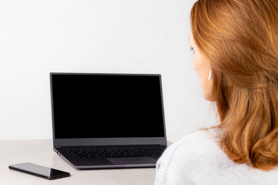 Rear view of woman using smart phone