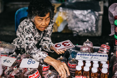 Woman with vegetables for sale in market