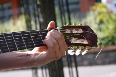 Midsection of person playing guitar