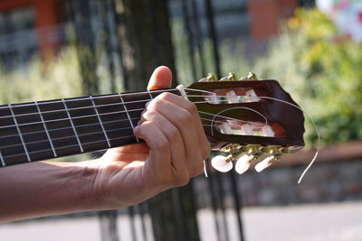 Cropped hand of person playing guitar