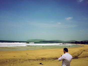 Scenic view of beach against blue sky