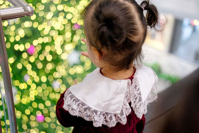 Rear view of girl standing outdoors