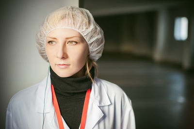 Female doctor standing in hospital lobby