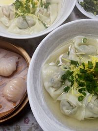 High angle view of fresh dumplings in bowls on table